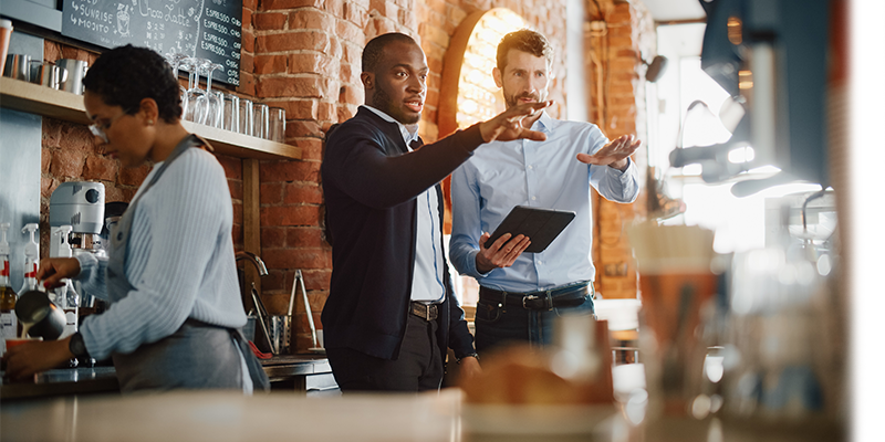 Two business owners talking in their restaurant
